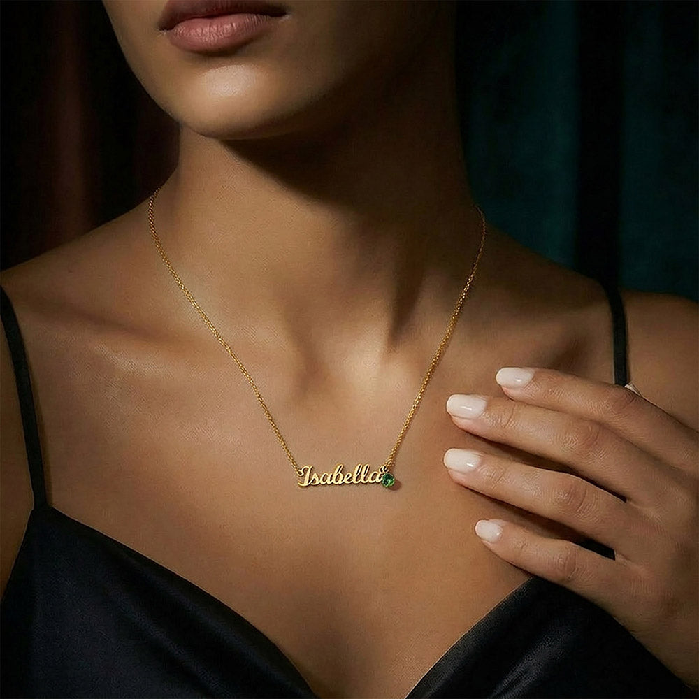 Woman wearing the gold name necklace with birthstone