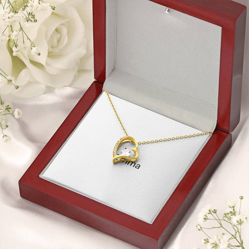 Gold Forever Love necklace in a gift box with white roses