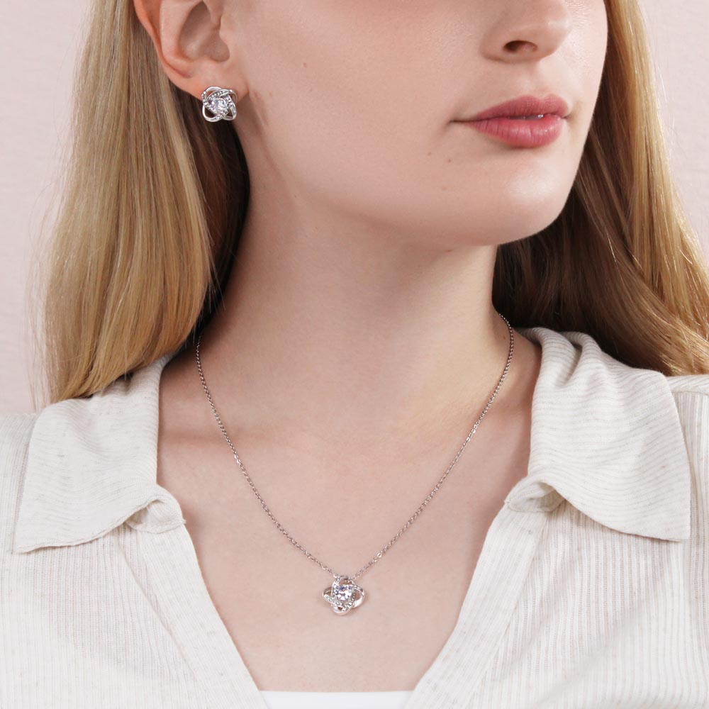 Woman wearing the Love Knot necklace and earring set