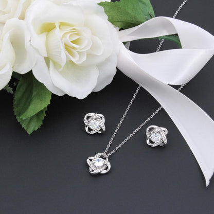 Love knot jewellery set styled with a white rose