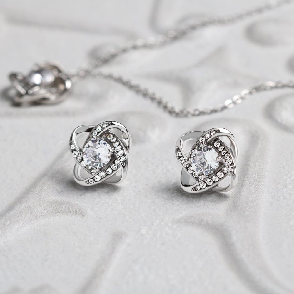 Love knot necklace and earrings, close up on the crystal detail