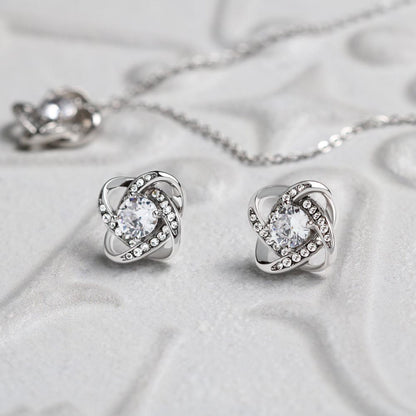 Love knot necklace and earrings, close up on the crystal detail