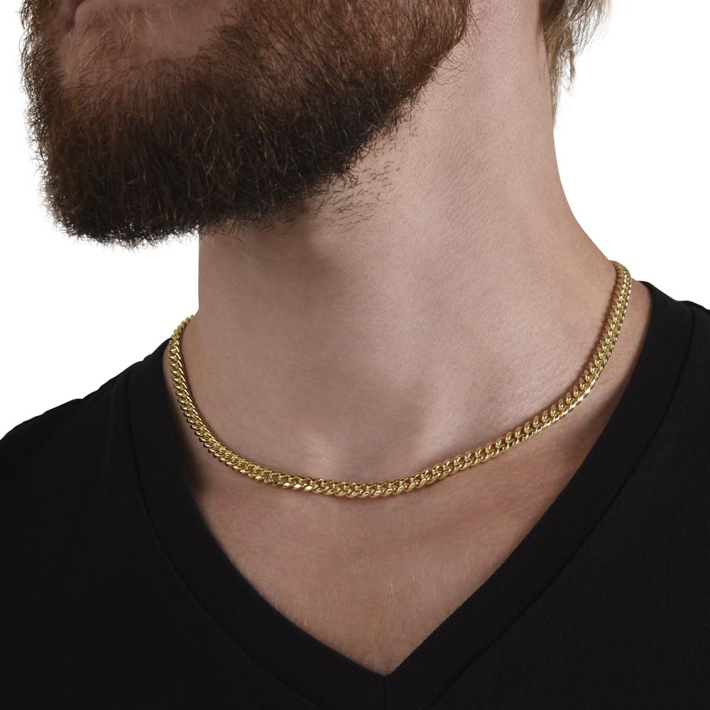 Gold Cuban link chain worn, close up