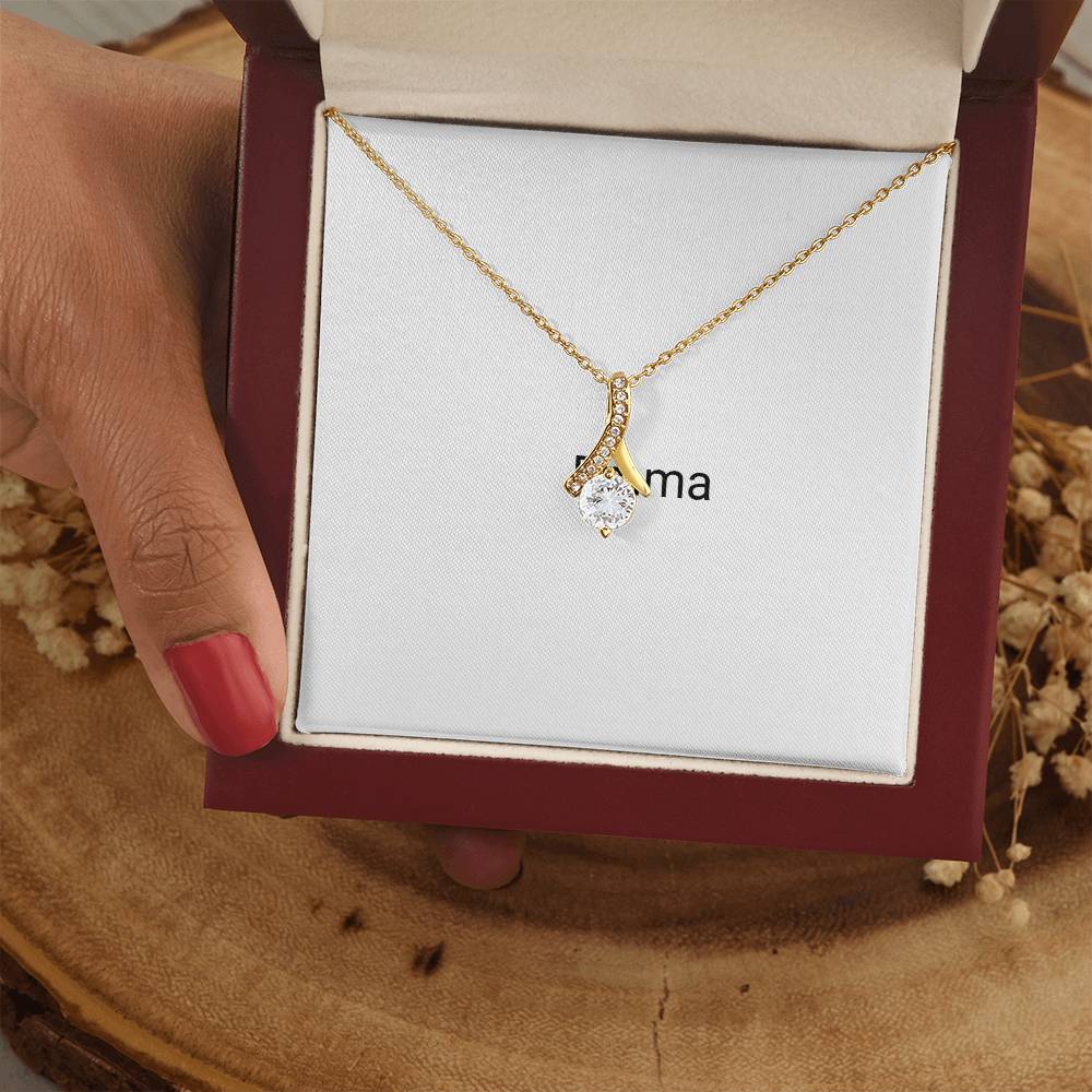 Gold Alluring Beauty necklace in a gift box, held