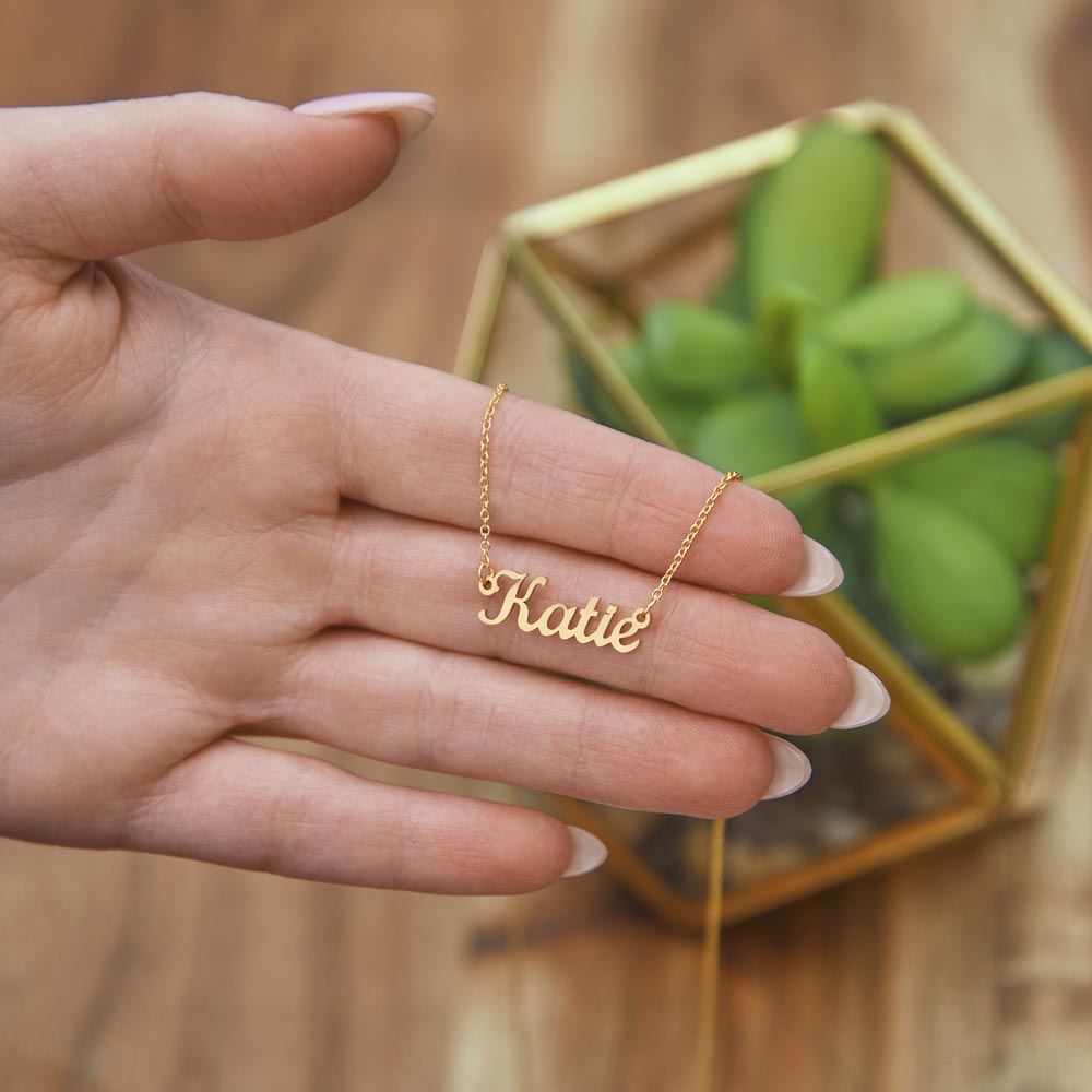 Personalized gold cursive name necklace, styled detail