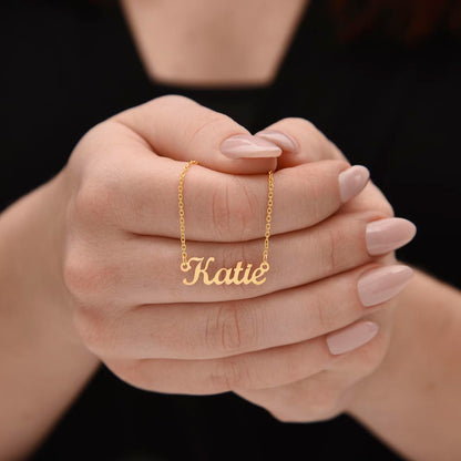 Gold name necklace held in hands, a personalized gift