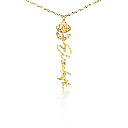Gold name necklace with a delicate flower and birthstone, close up