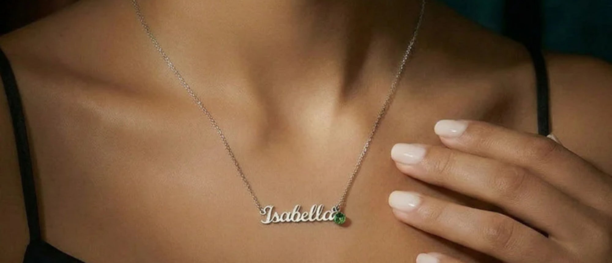Personalized gold name necklace with birthstone worn close up